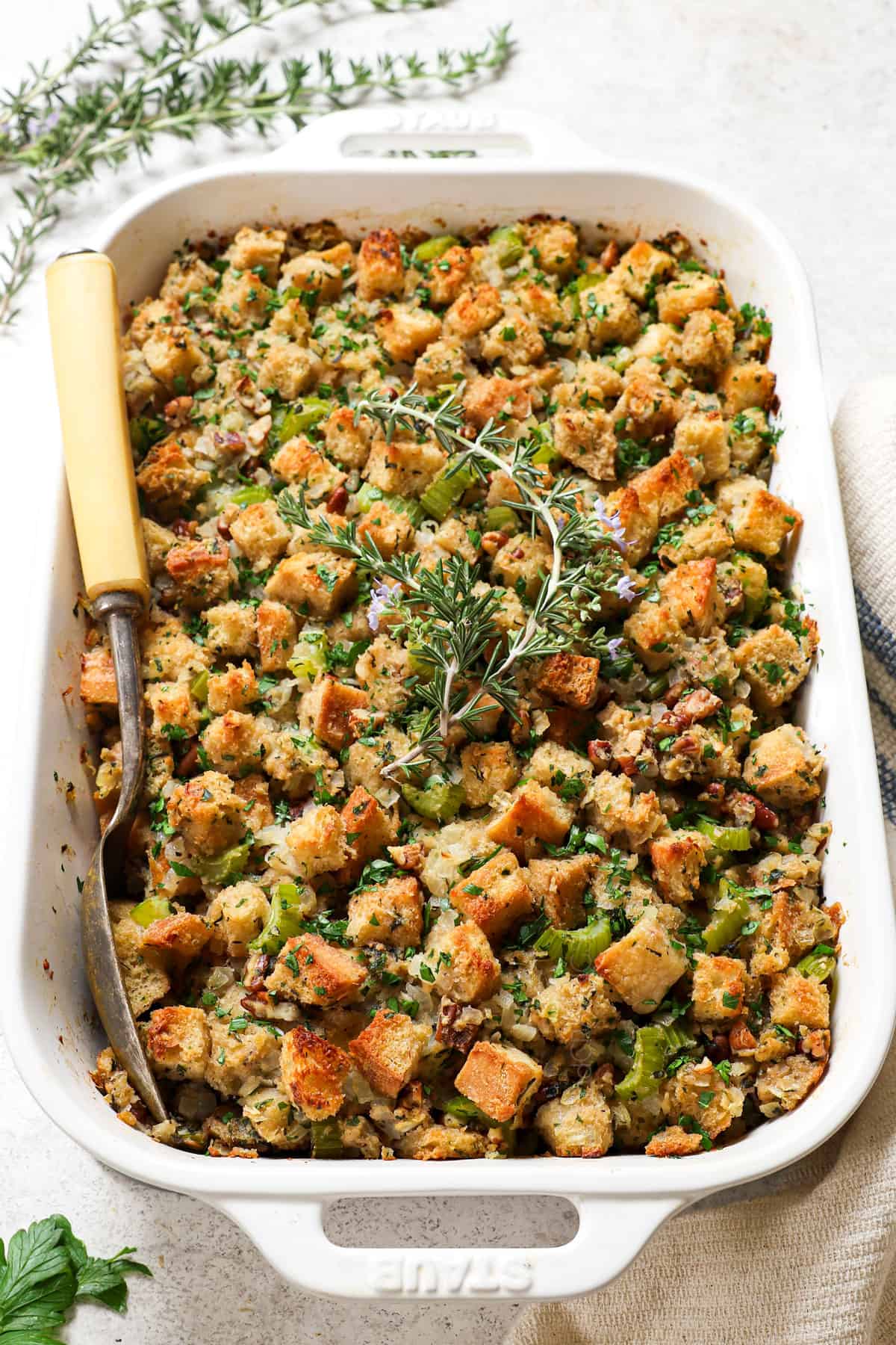 dressing recipe in a casserole dish garnished by rosemary