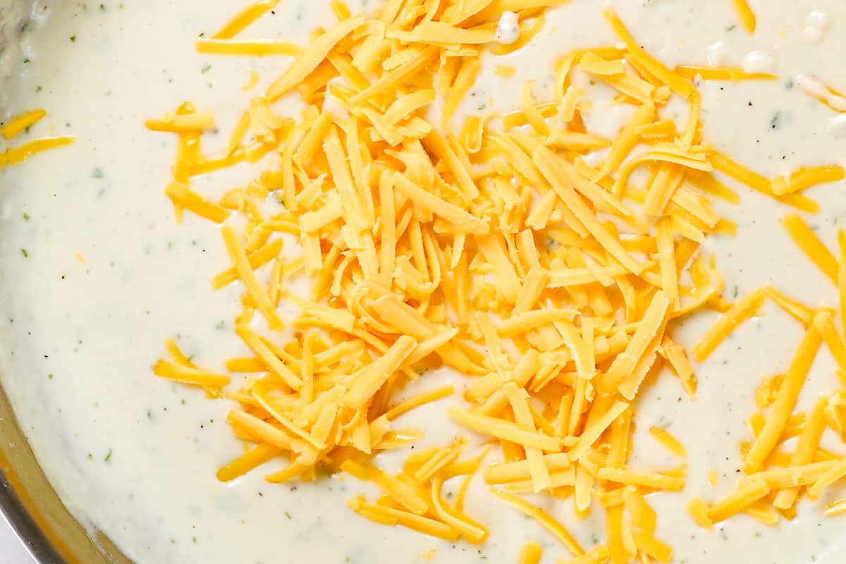 showing how to make broccoli casserole by adding cheese to the sauce