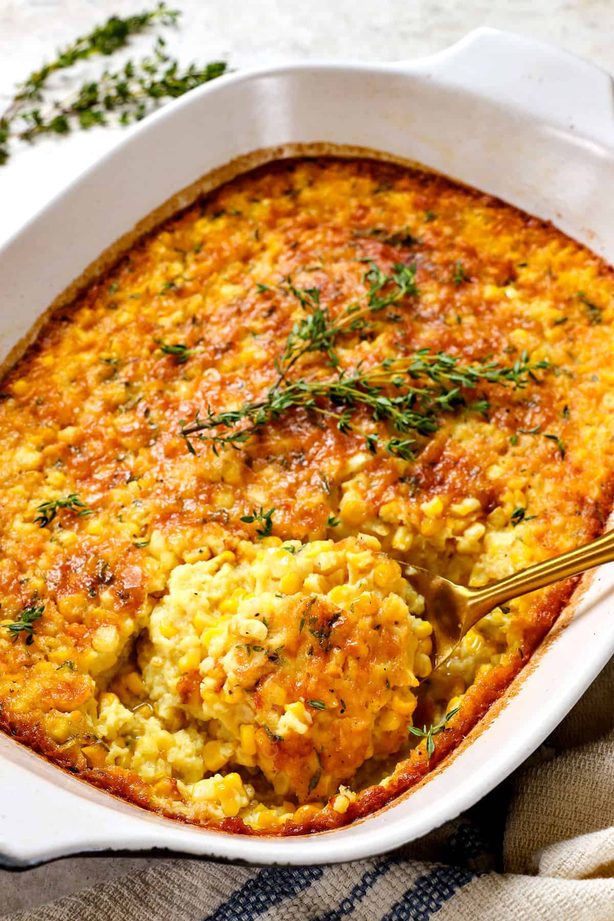 garnishing corn pudding casserole with fresh thyme