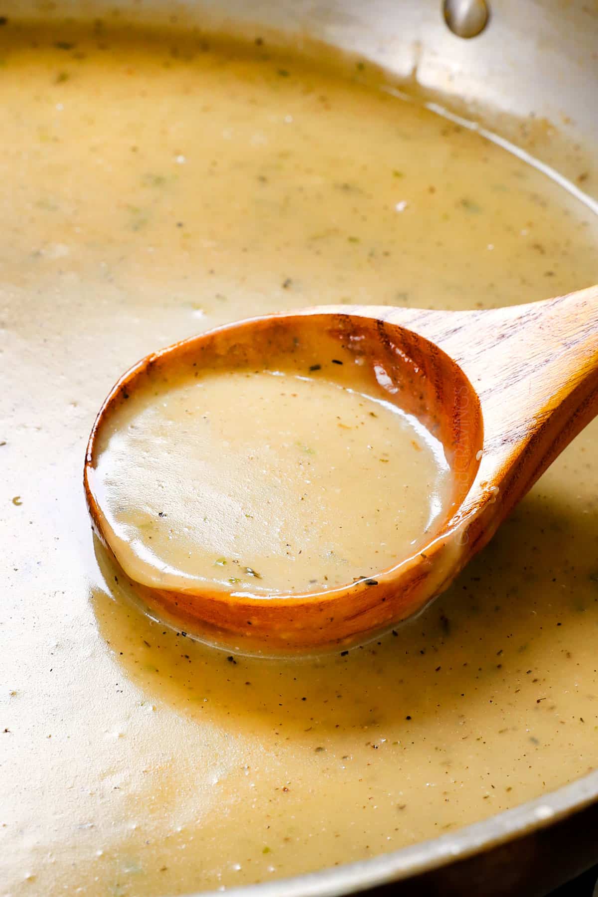 stirring turkey gravy with drippings in a skillet