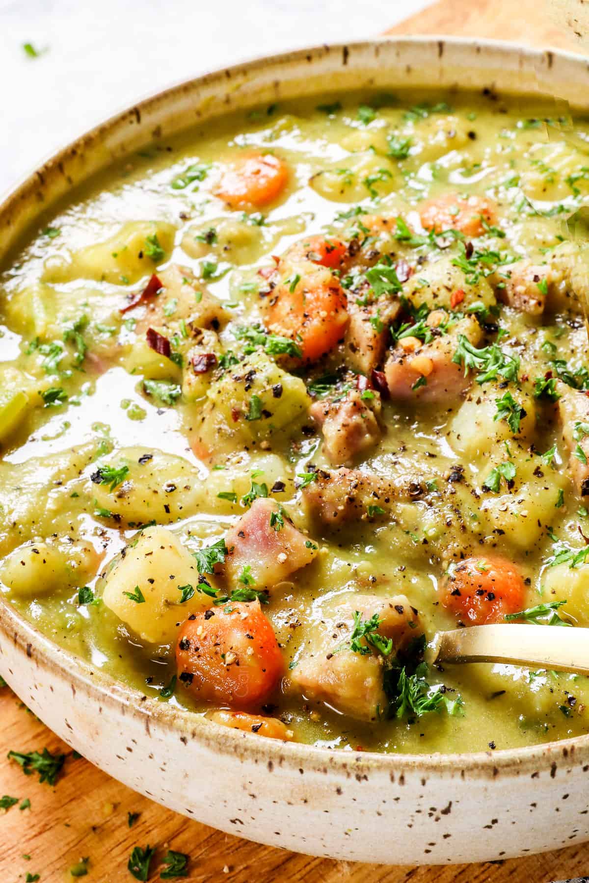 up close of a spoonful of split pea and ham soup showing the consistency