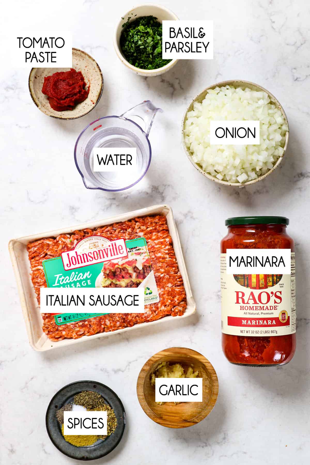 top view showing ingredients for lasagna roll ups meat sauce: sausage, marinara, tomato sauce, onions, water, and herbs