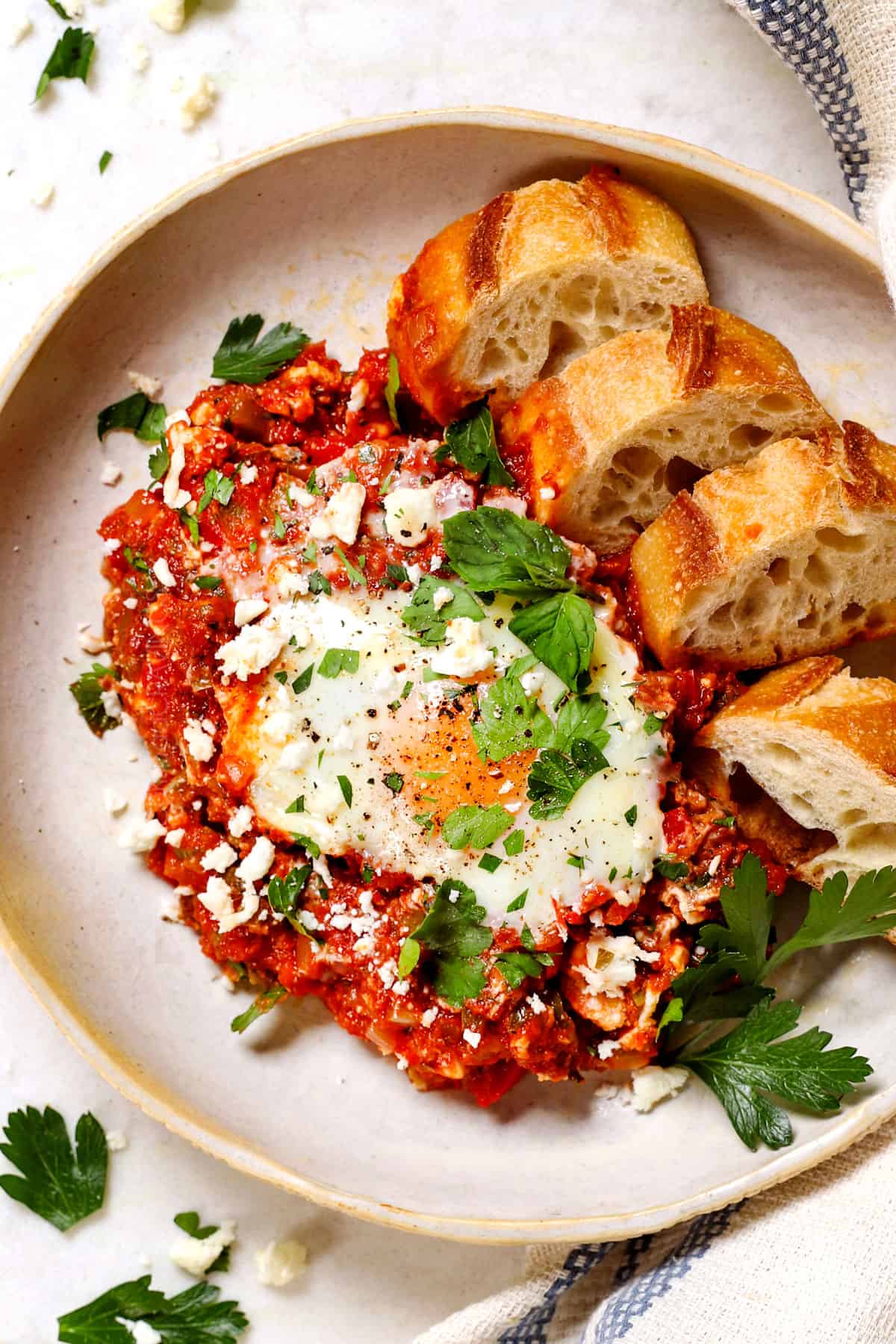 top view of shakshuka on a plate with bread