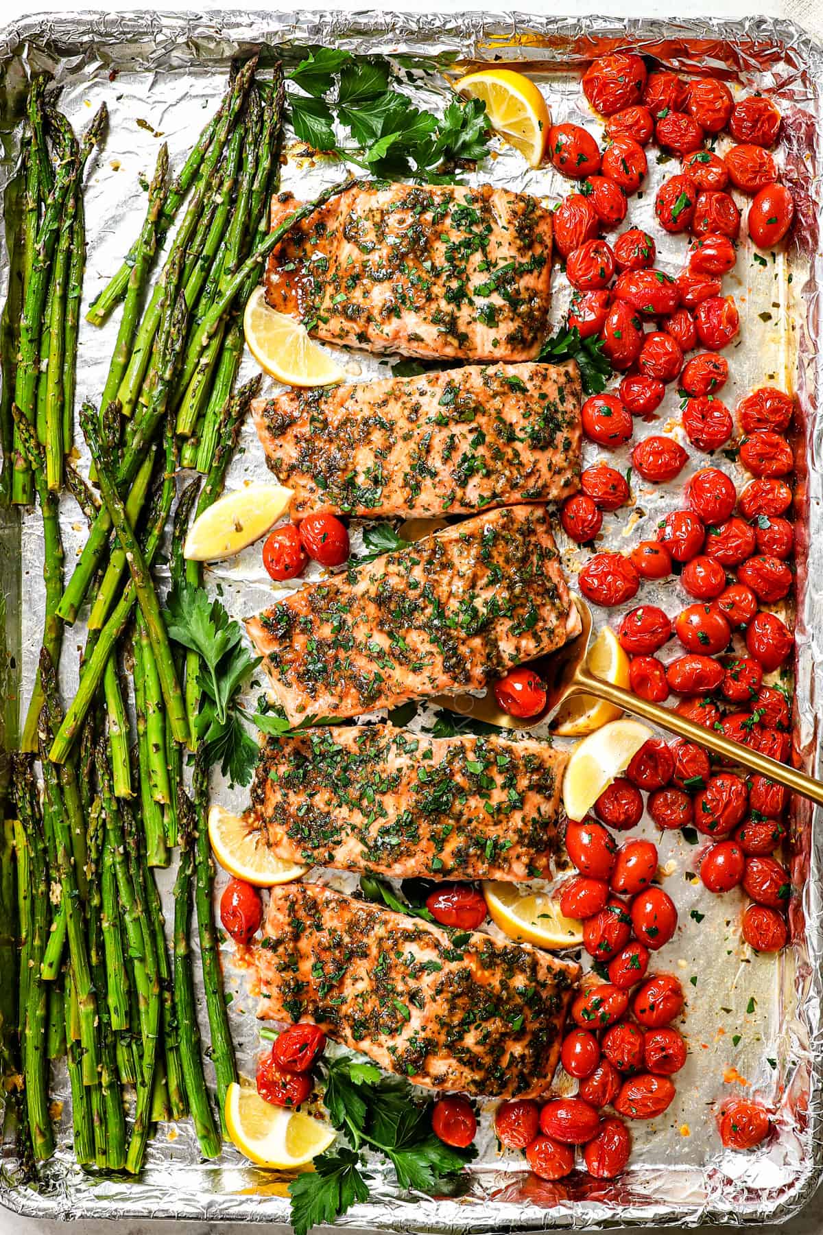 top view of baked salmon in oven with garlic, lemon and herbs