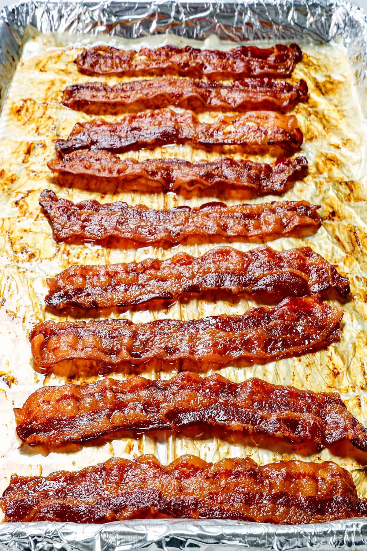 cooking bacon in oven lined on a baking sheet showing how far to space the bacon