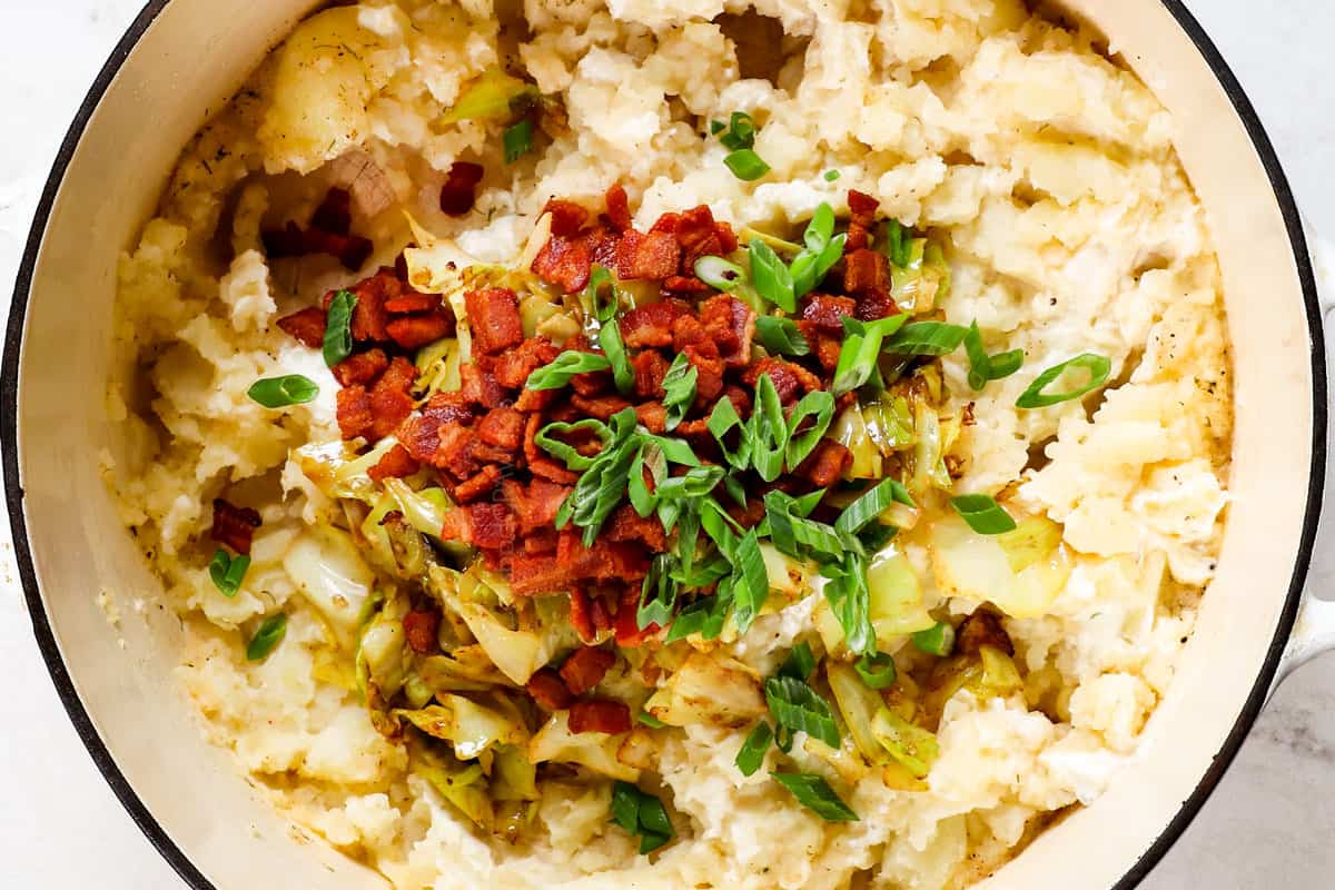 showing how to make colcannon by adding cabbage, bacon and green onions