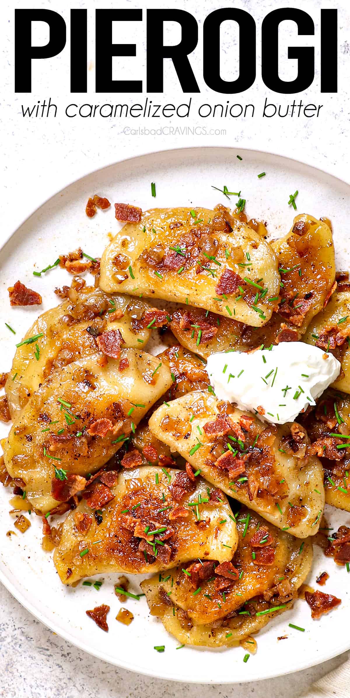 top view of pierogi recipe being served on a plate with sour cream