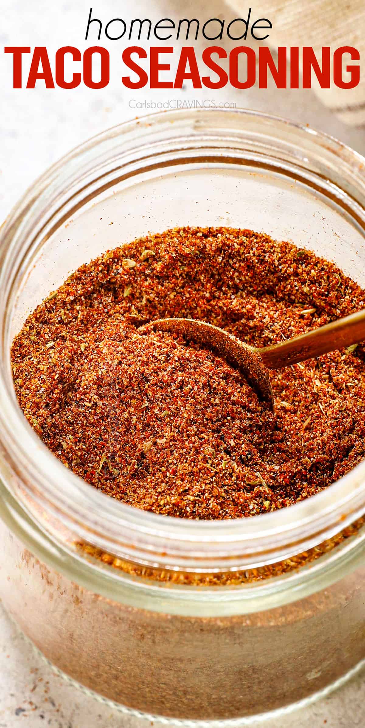 up close of adding taco seasoning to an airtight container