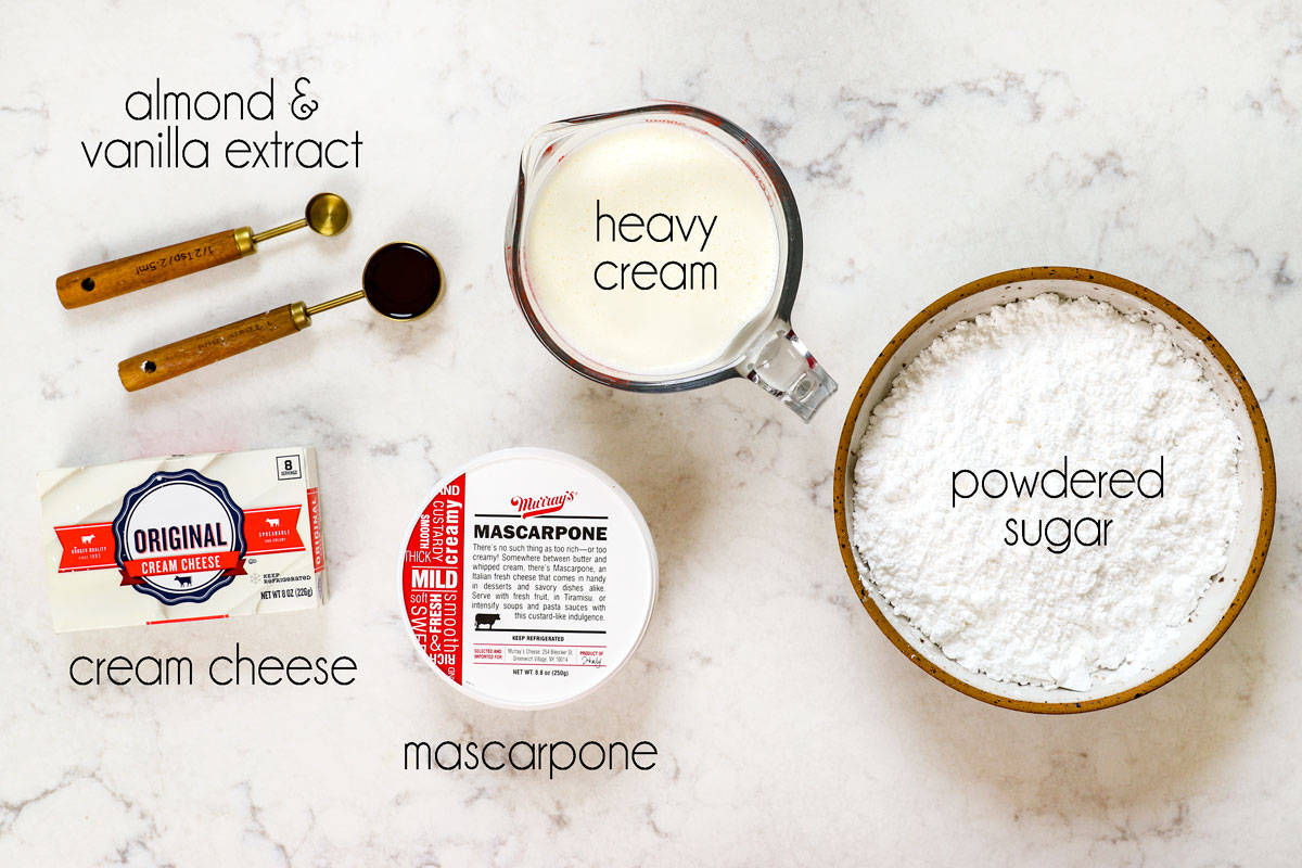 top view showing ingredients for frosting (Chantilly cream) for Chantilly Cake: heavy cream, sugar, mascarpone, cream cheese, vanilla extract, almond extract