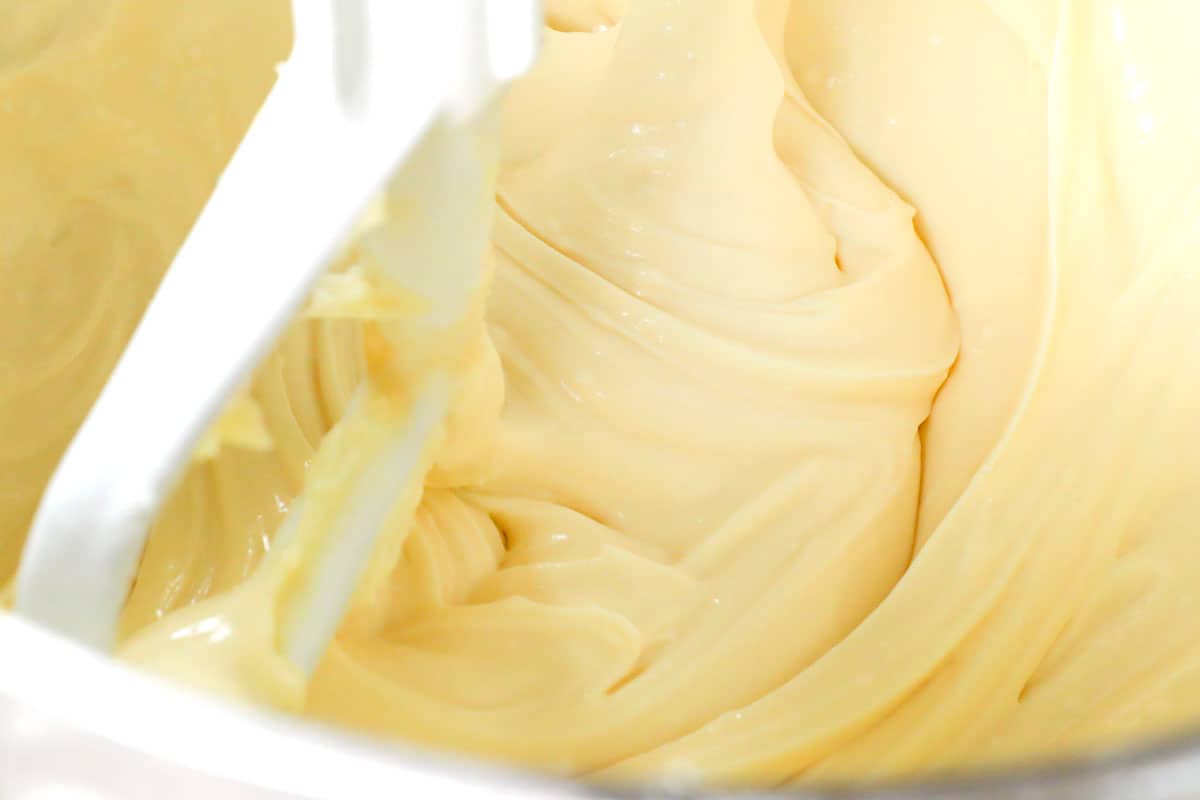 showing how to make Chantilly cake by beating cream cheese, mascarpone and sugar until creamy