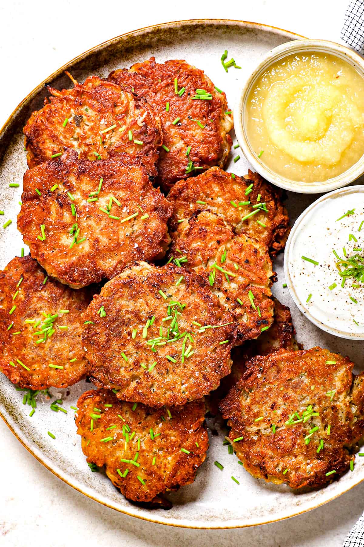 top view showing how to serve potato pancakes on a platter garnished with green onions