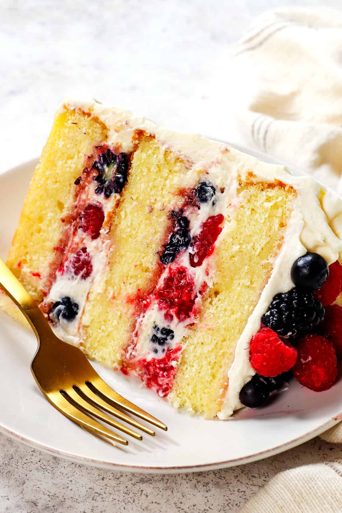 a slice of Chantilly cream cake on a plate showing the layers