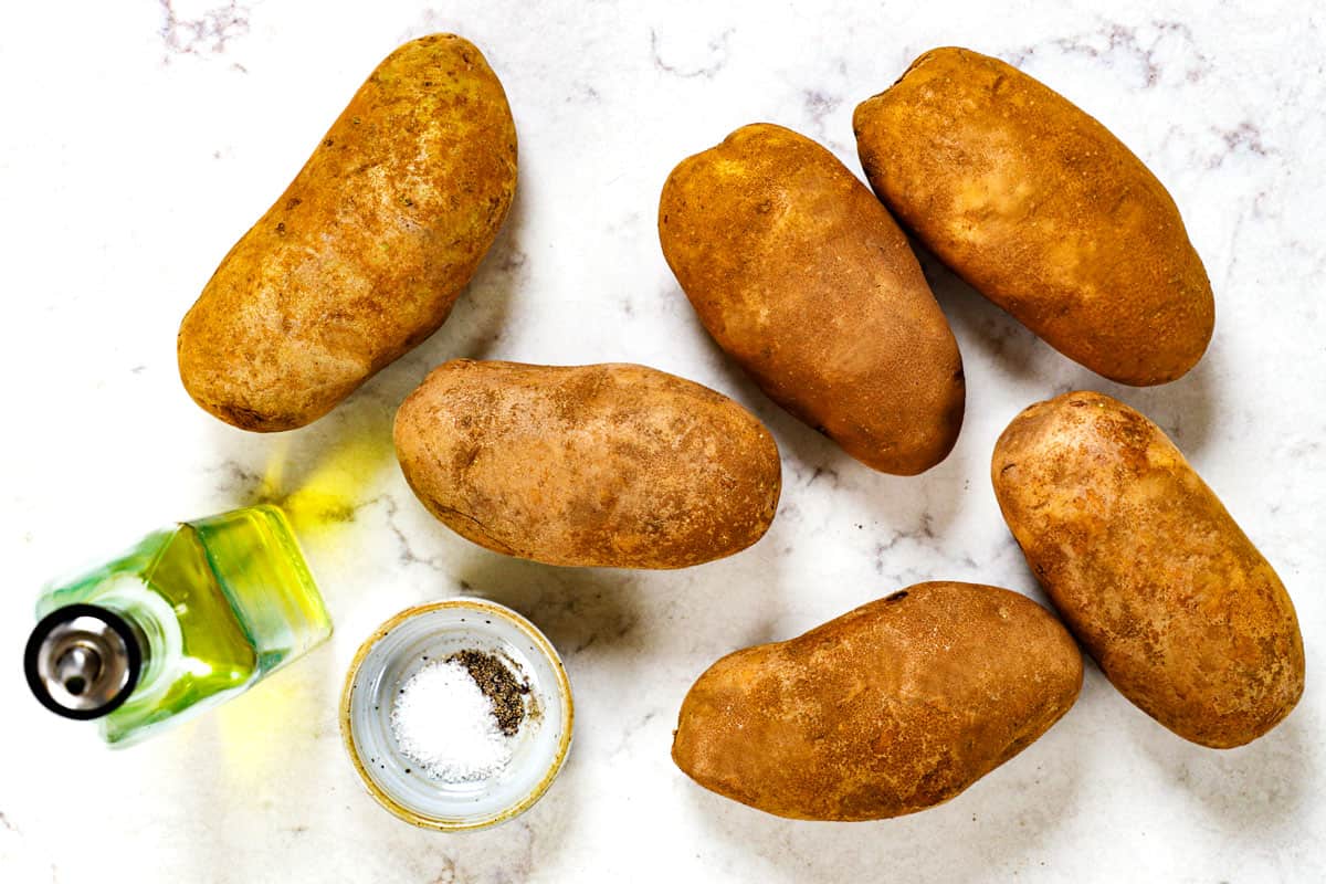 showing ingredients for baked potato recipe: Russet potatoes, olive oil, salt and pepper