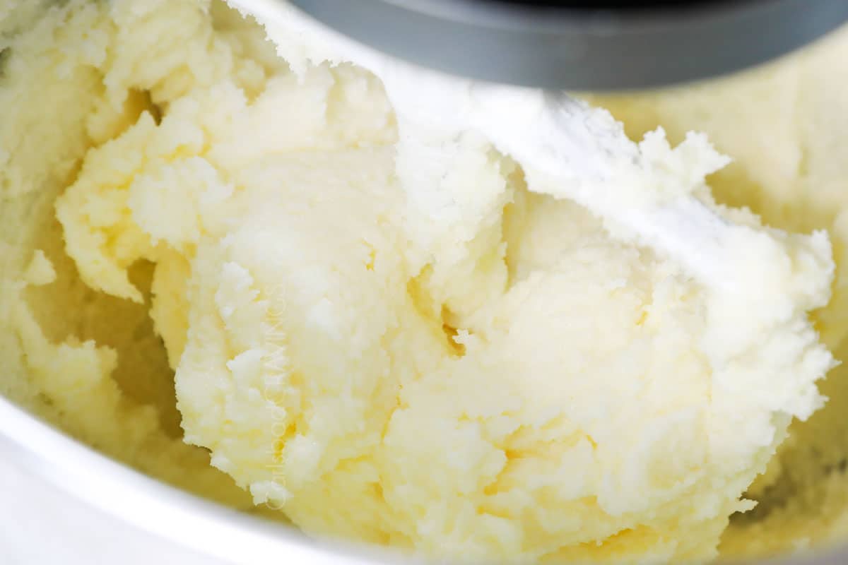 showing how to make lemon poppy seed cake by creaming the butter and sugar together