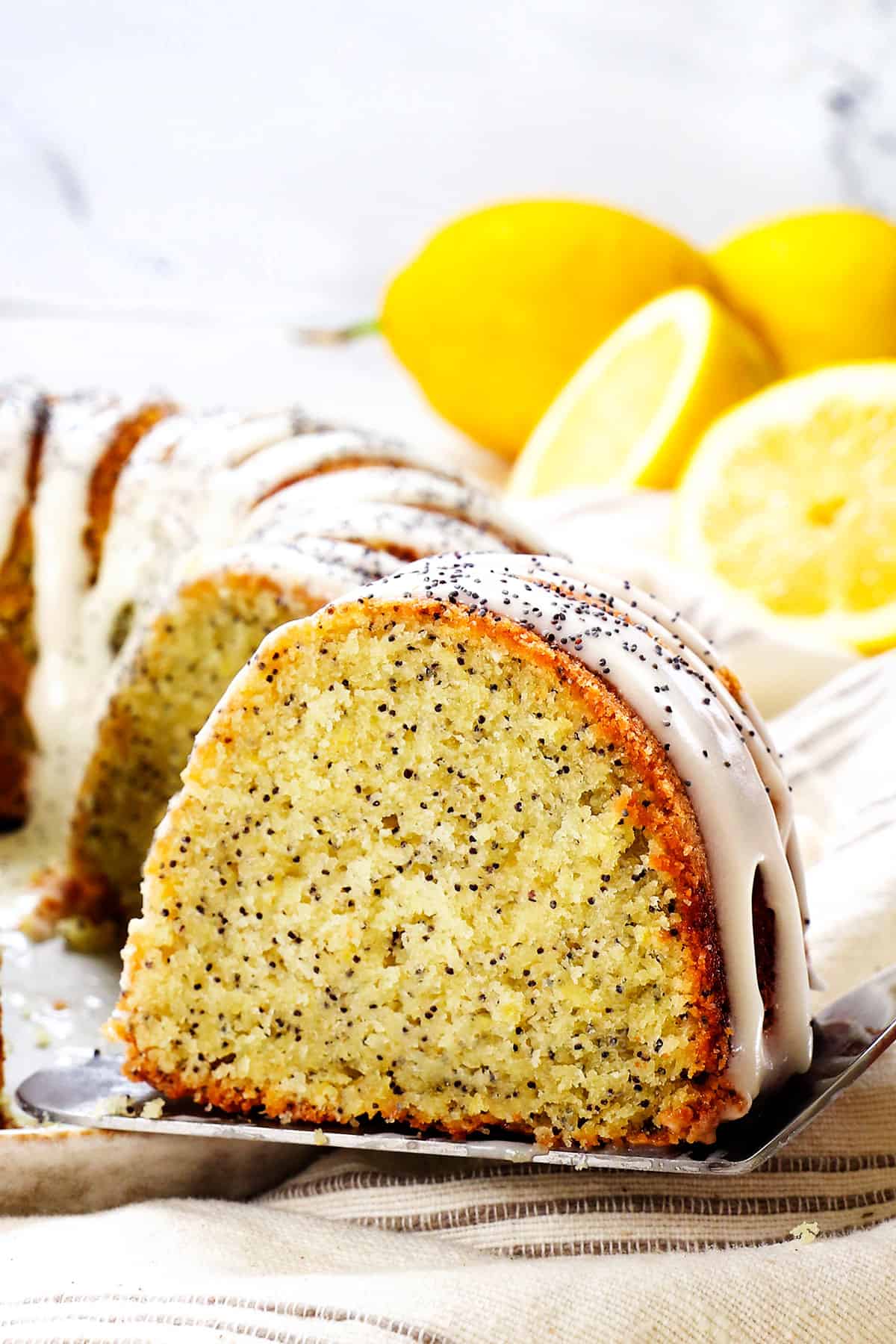 a slice of lemon poppy seed on a cake server