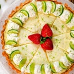 top view of key lime pie garnished with lime slices and whipped cream