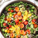 top view of summer salad with cherries, peaches, mangos, avocado and tomatoes
