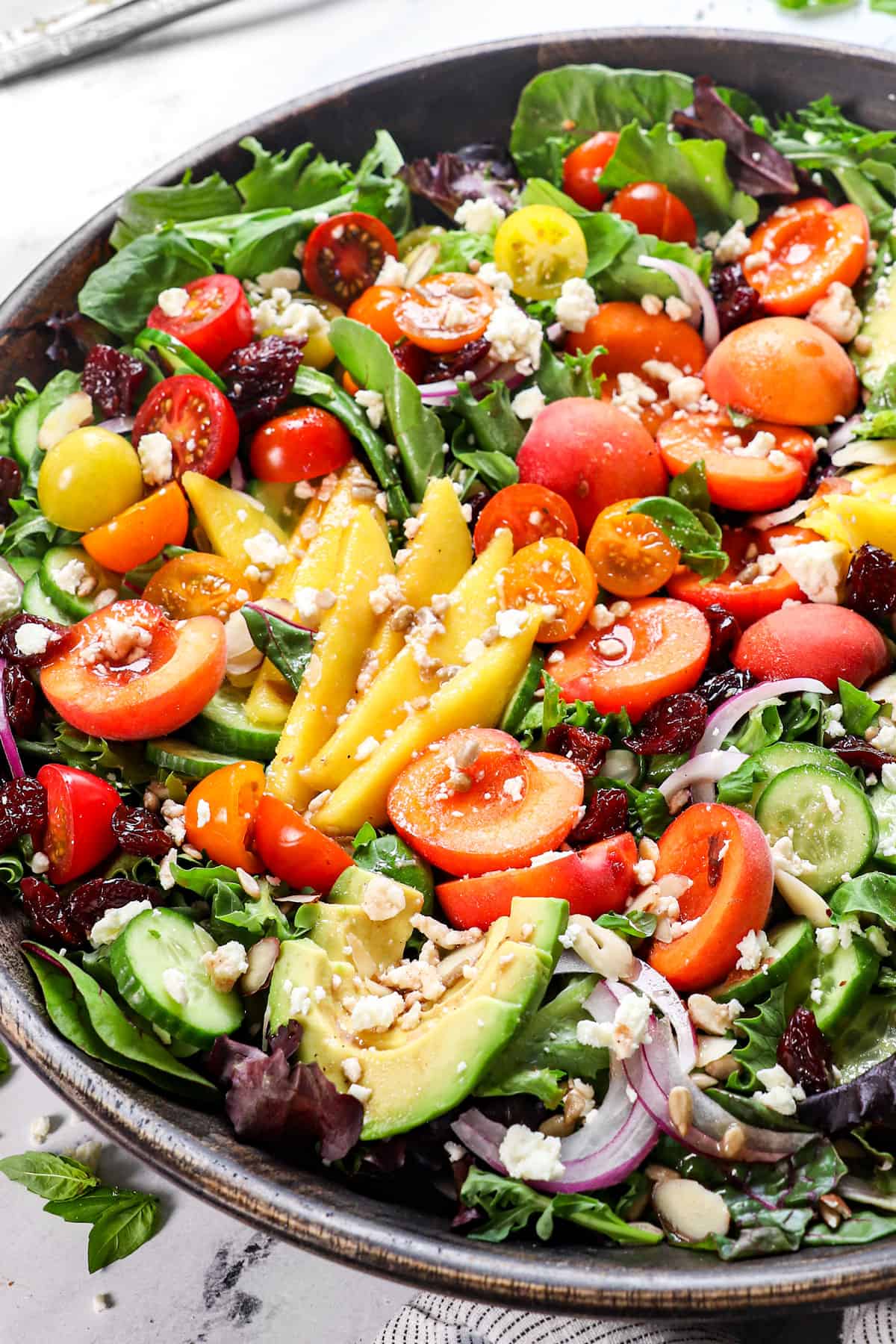 summer salad recipe with peaches in a wood bowl