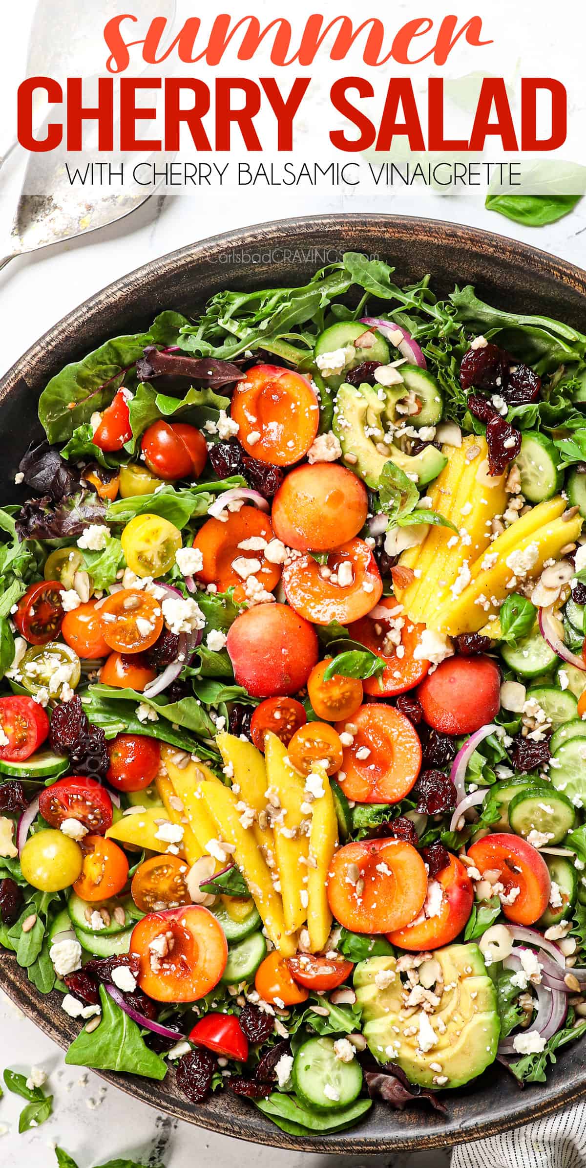 top view of summer salad with cherries, peaches, mangos, avocado and tomatoes