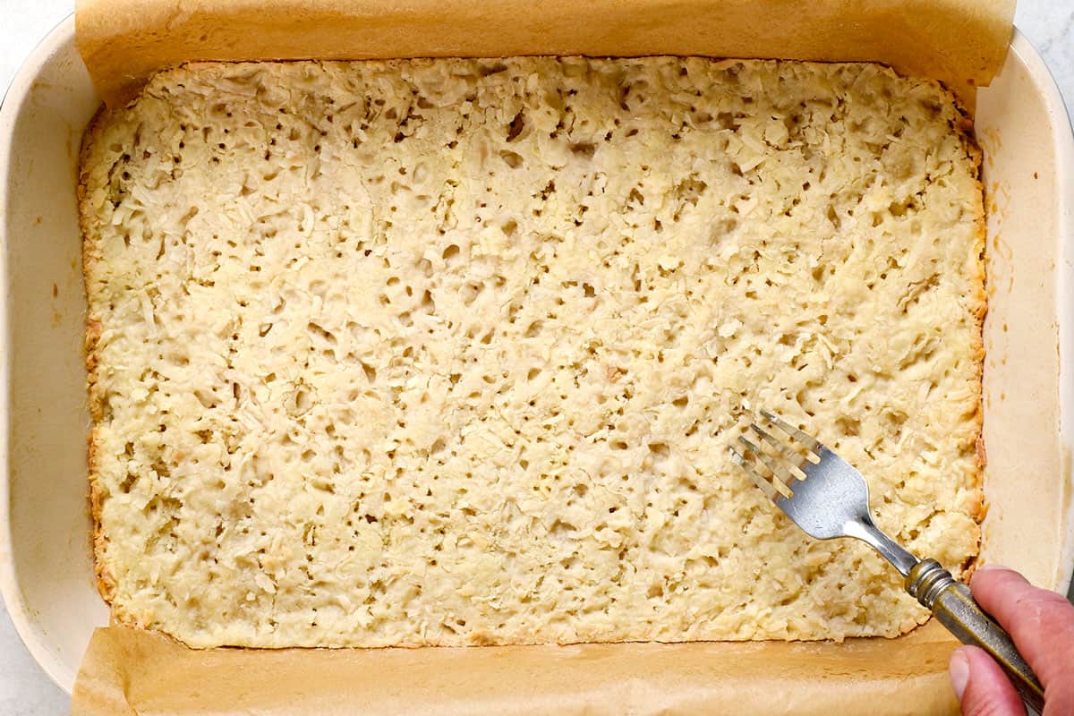 showing how to make lemon bars by baking the crust until lightly golden around the edges