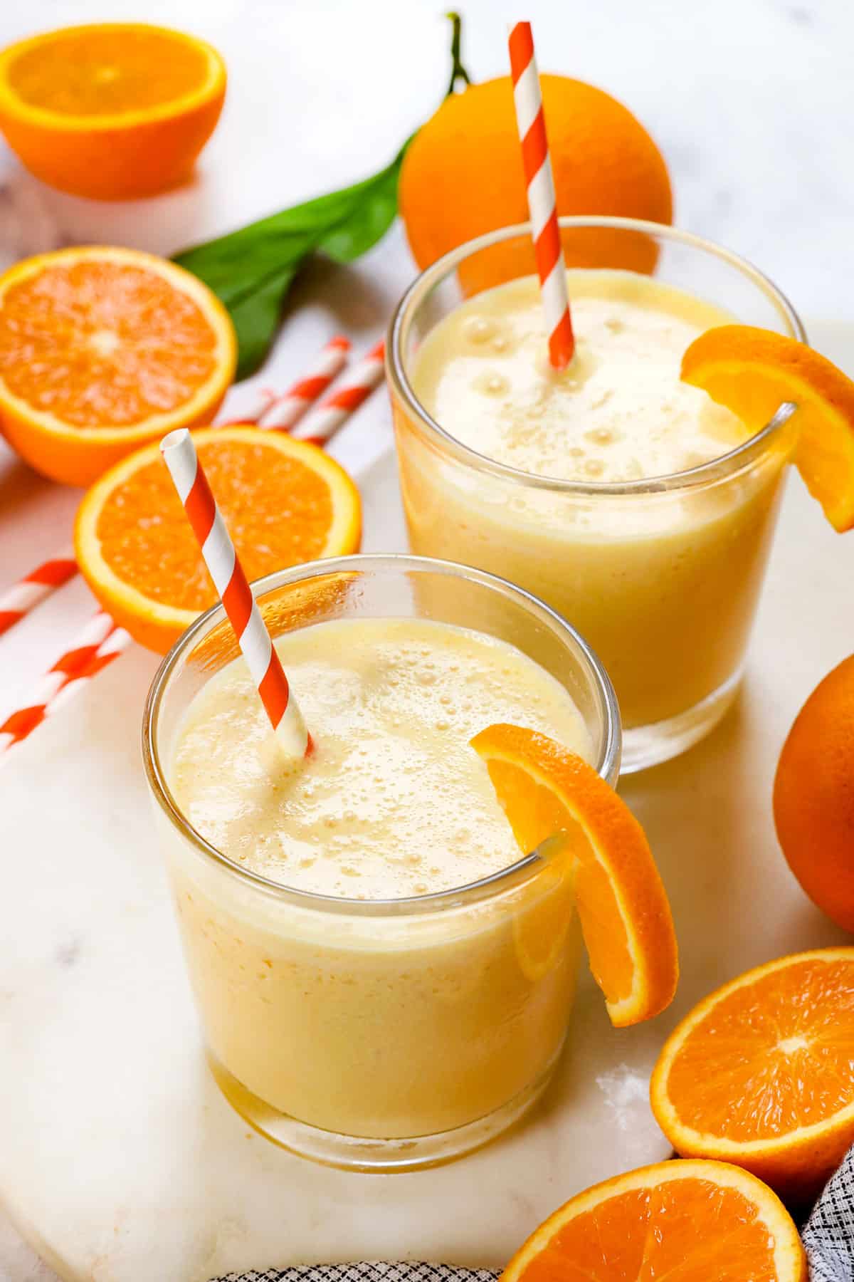 orange Julius recipe served in two glasses garnished with orange slices