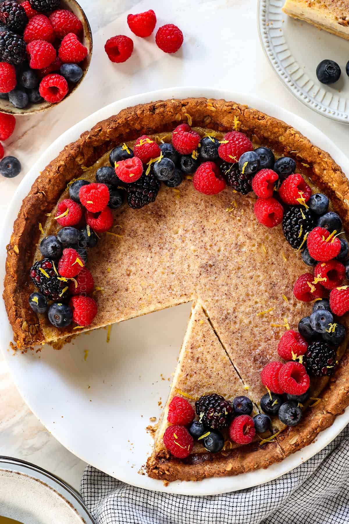showing how to serve custard pie by garnishing with berries