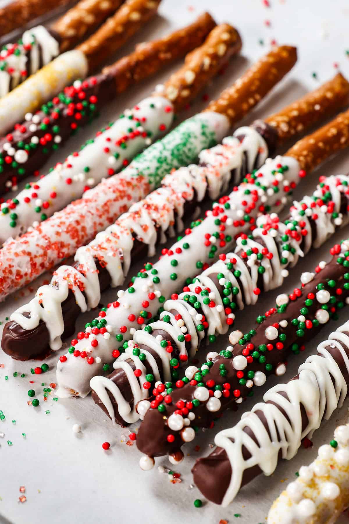 chocolate covered pretzels with white chocolate drizzle and sprinkles