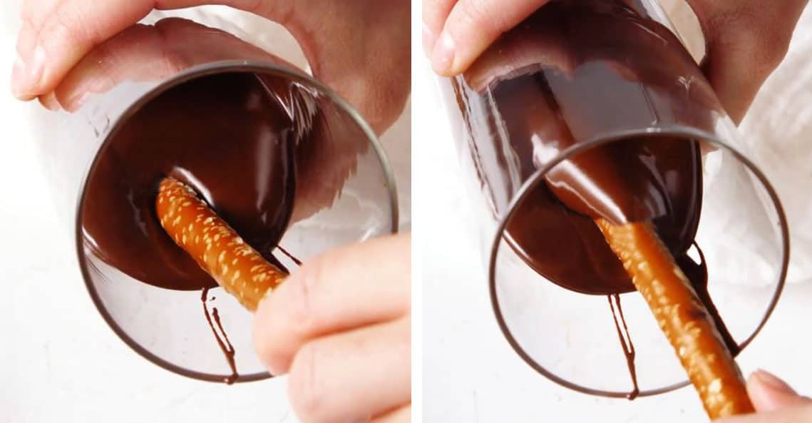 showing how to make chocolate covered pretzels by dipping them in a glass with chocolate and swirling to coat