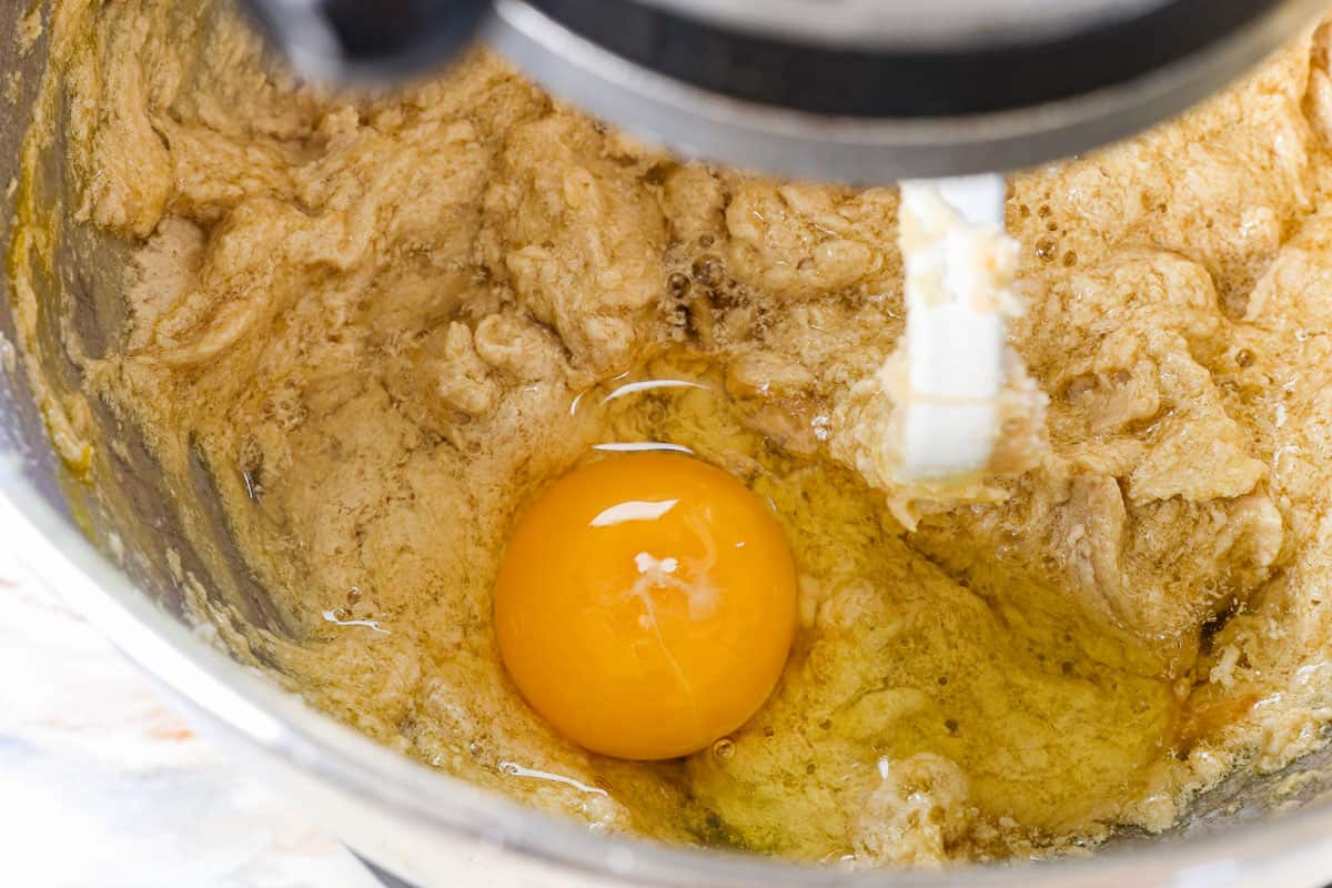 showing how to make coffee cake by mixing in the eggs, followed by the yogurt or sour cream