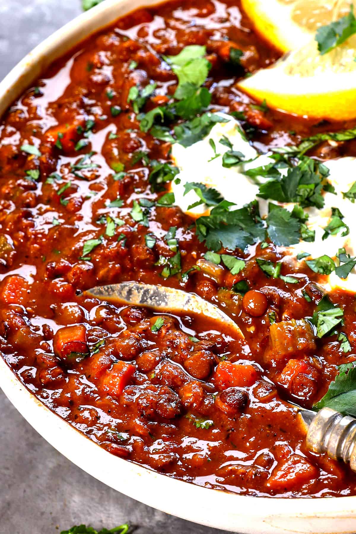 a spoon in a bowl of lentil soup recipe showing the creamy texture