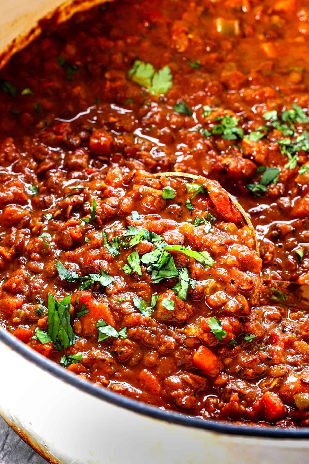 stirring vegan lentil soup showing the rich and creamy texture