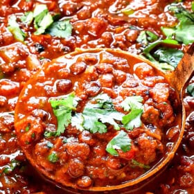 a large ladleful of lentil soup showing the thick and creamy consistency