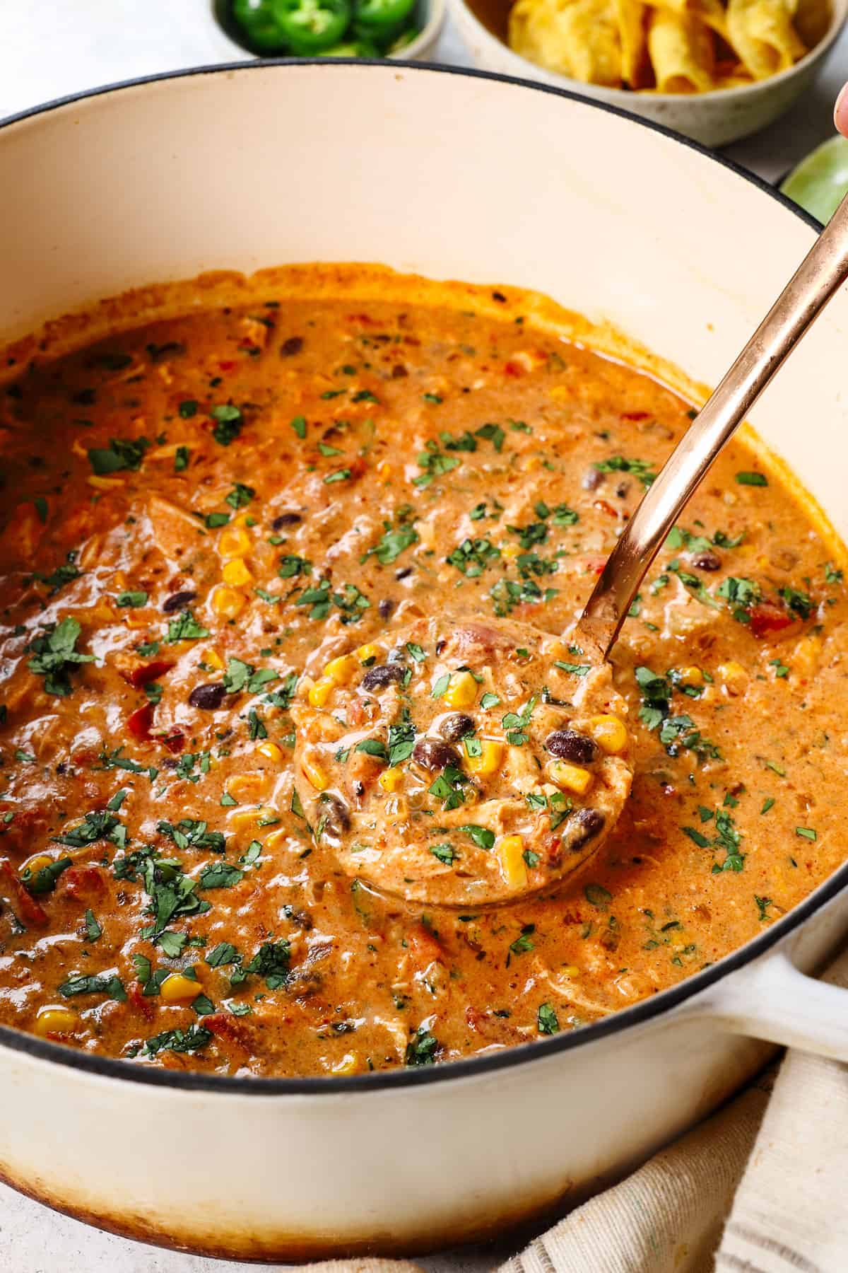 Taco chicken soup in Dutch oven garnished with cilantro