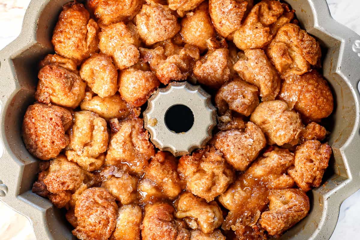 showing how to make monkey bread by baking the monkey bread until golden and cooked through