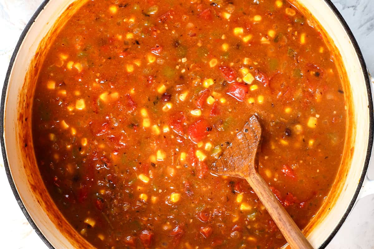 showing how to make chicken taco soup by simmering until the chicken is tender