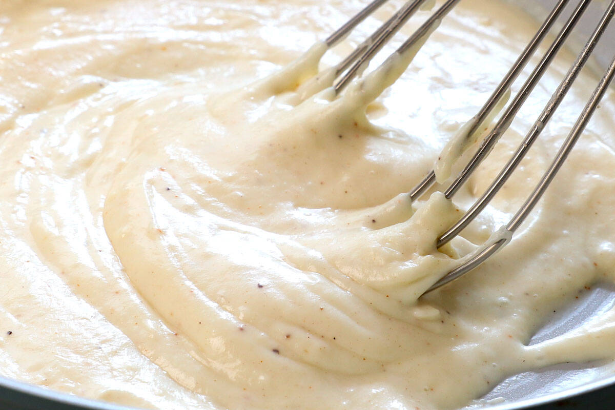 showing how to make croque monsieur by simmering the béchamel until thickened