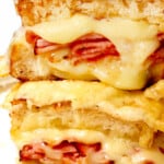 showing the best croque monsieur recipe by stacking the sandwiches cut in half showing the cheesy, creamy inside