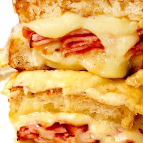 showing the best croque monsieur recipe by stacking the sandwiches cut in half showing the cheesy, creamy inside