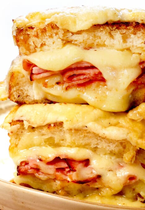 showing the best croque monsieur recipe by stacking the sandwiches cut in half showing the cheesy, creamy inside