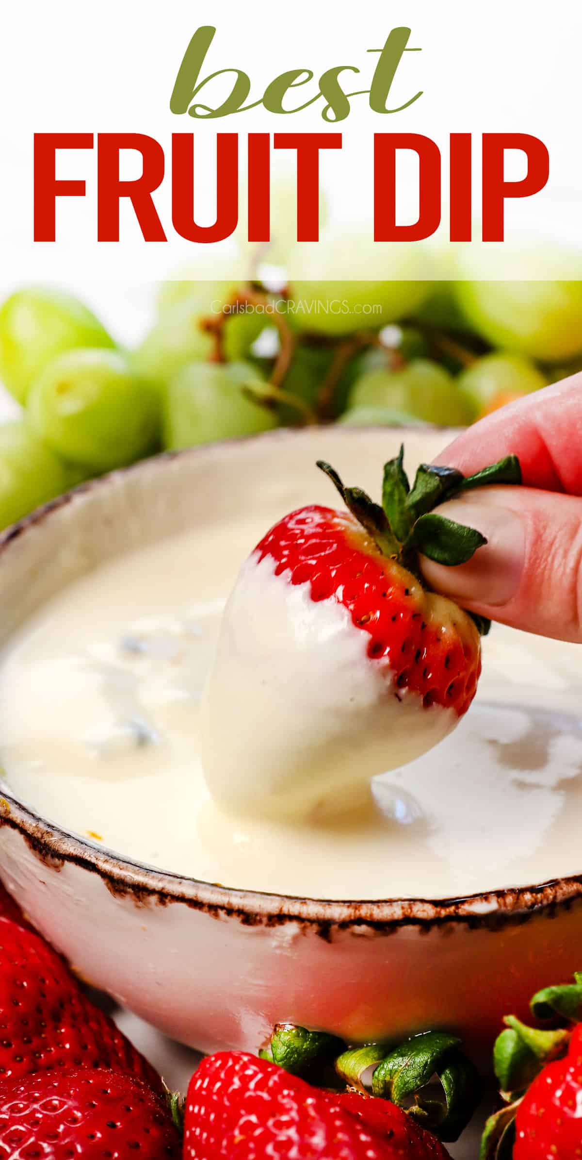 up close of dipping a strawberry in fruit dip showing how creamy it is
