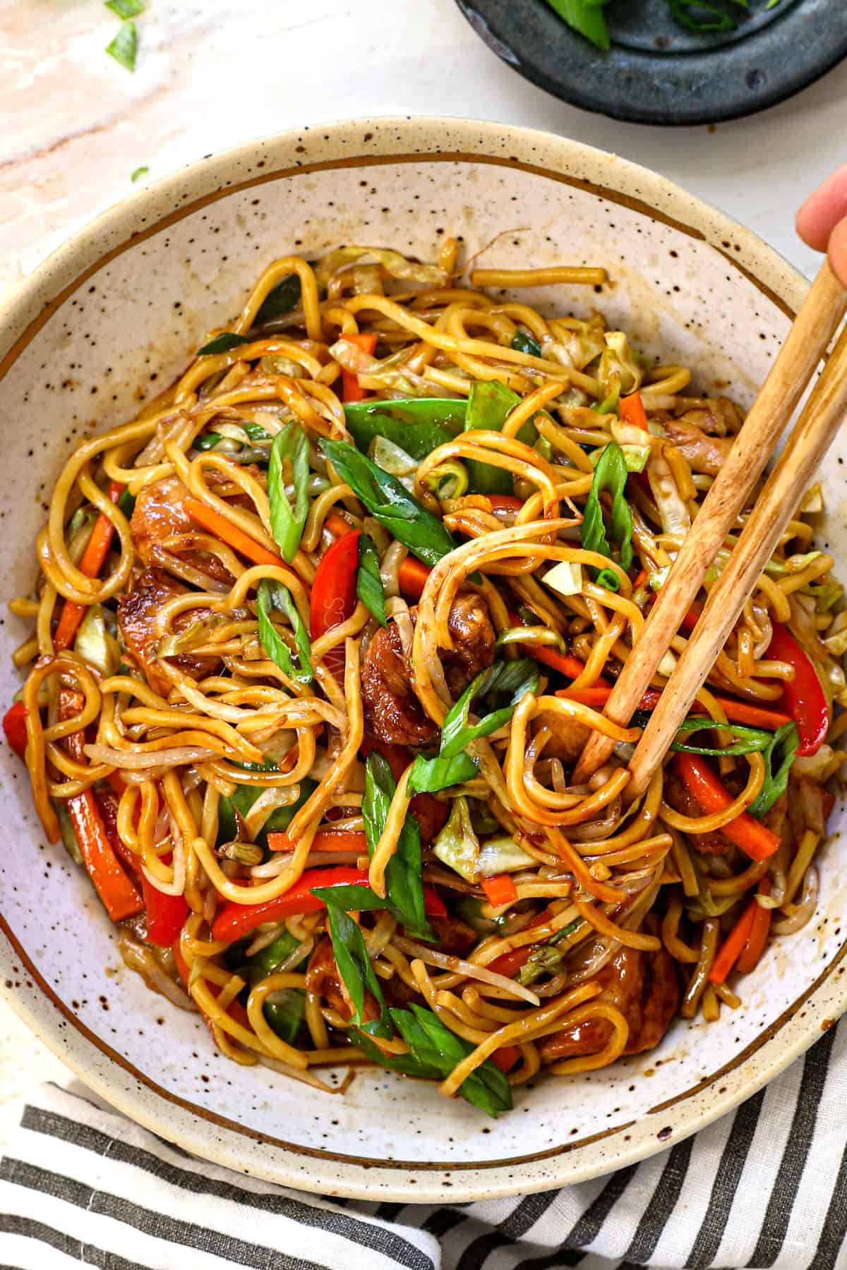 top view showing how to eat chicken lo mein recipe by twirling the noodles with chopsticks