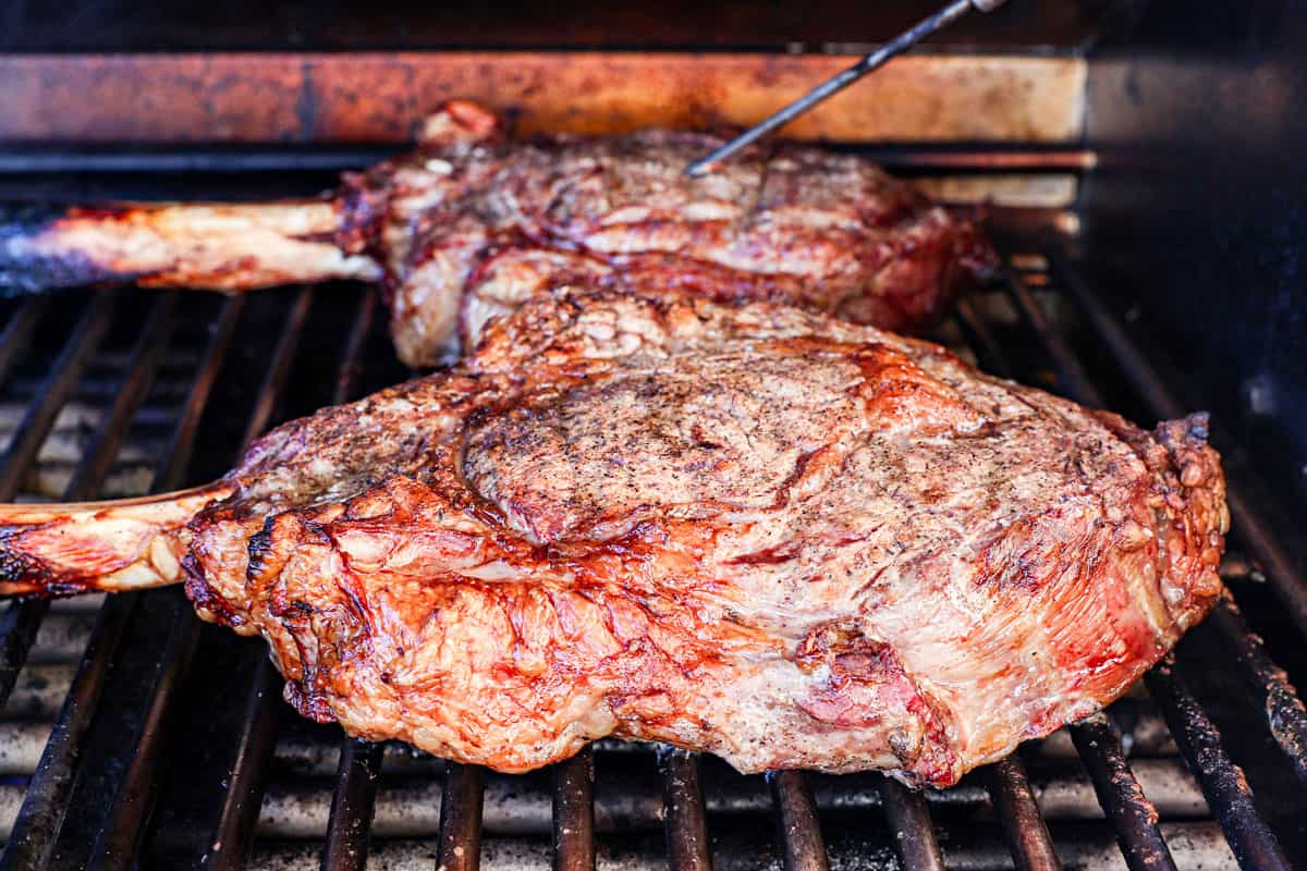 showing how to cook tomahawk steak by reverse searing on the grill until they reach 115 degrees F.