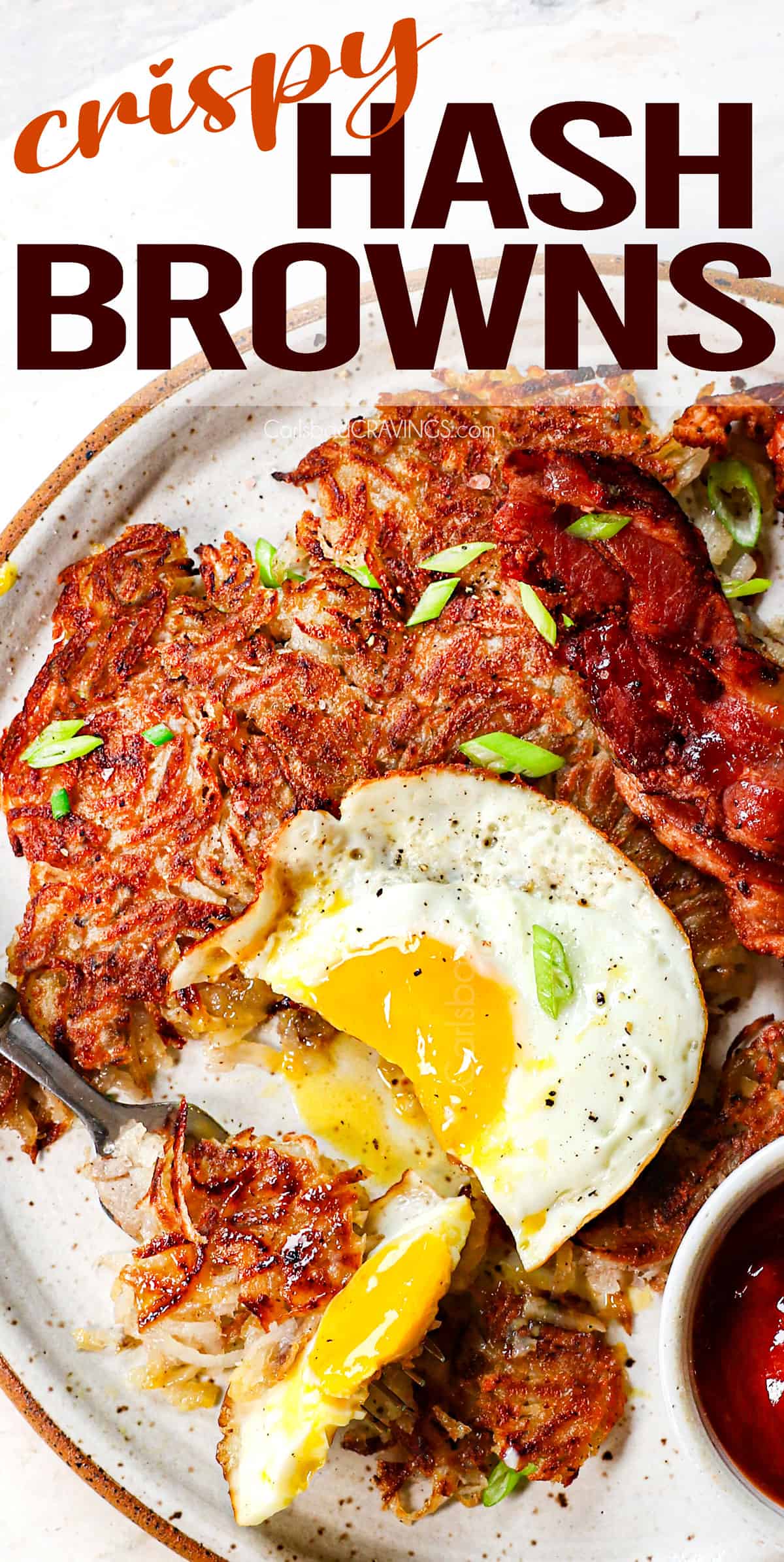 top view of hash browns on a plate with egg and bacon
