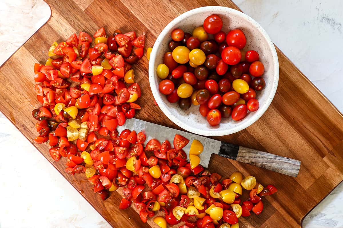 showing how to make bruschetta by coring and chopping the tomatoes on a cutting board and leaving the seeds behind