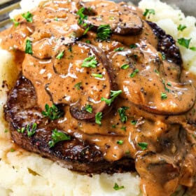 Beef Steak Diane Recipe being served over mashed potatoes, showing how creamy the gravy is