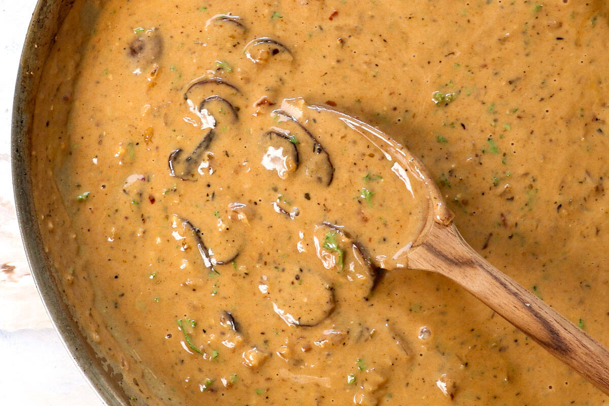showing how to make Steak Diane by simmering the sauce to thicken
