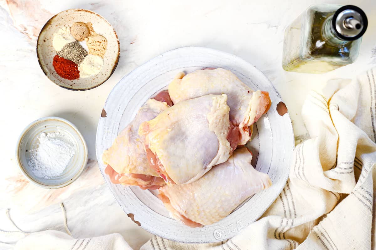 air fryer chicken thighs ingredients: bone-in chicken thighs, olive oil, spices and baking powder