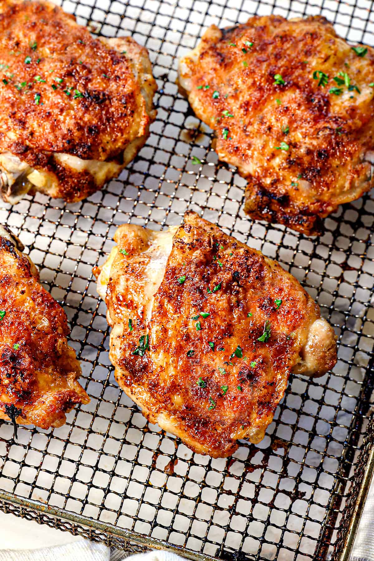 showing how to cook chicken thighs in air fryer by cooking until crispy