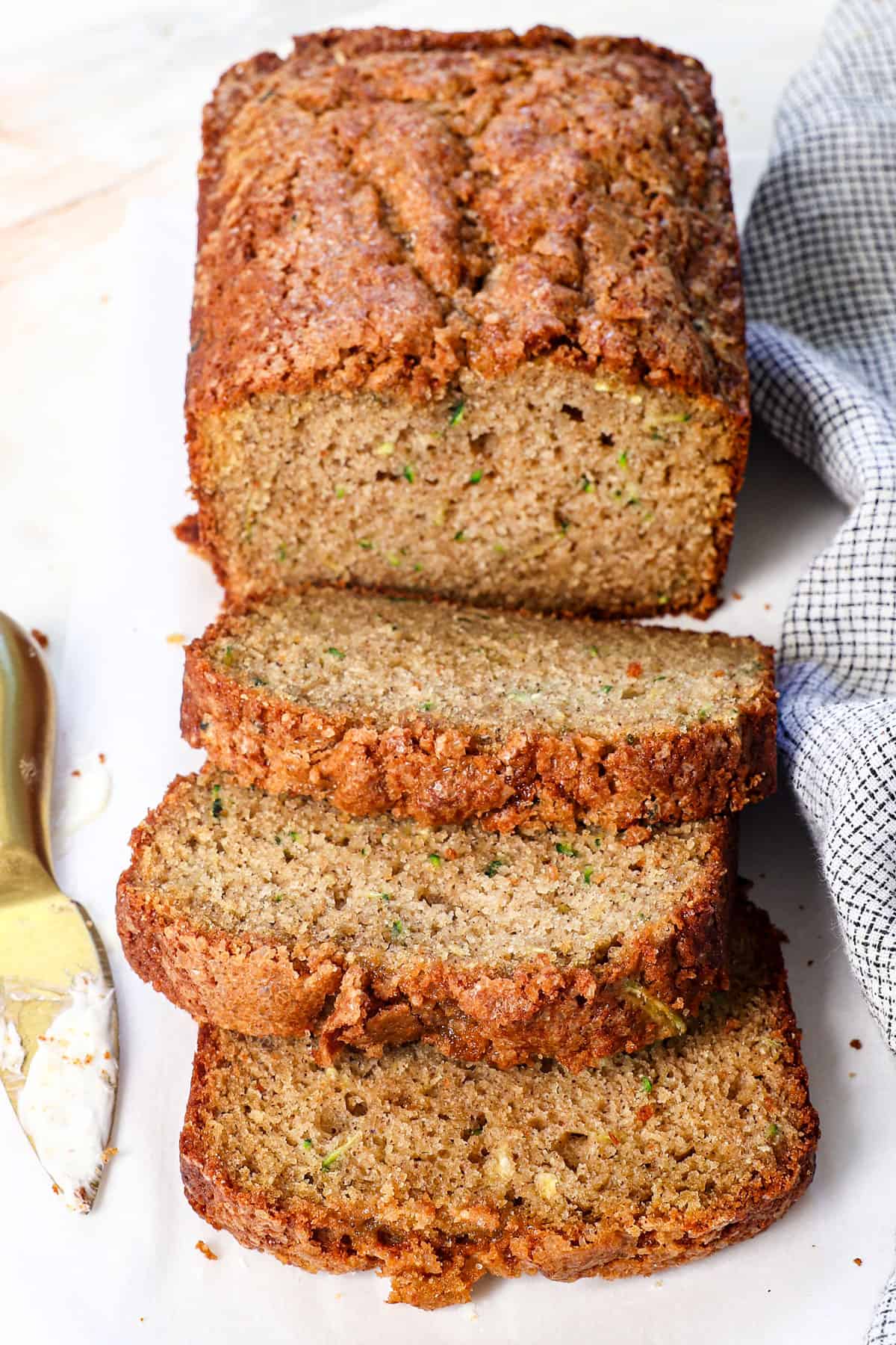 zucchini bread recipe on a cutting board made with fresh zucchini