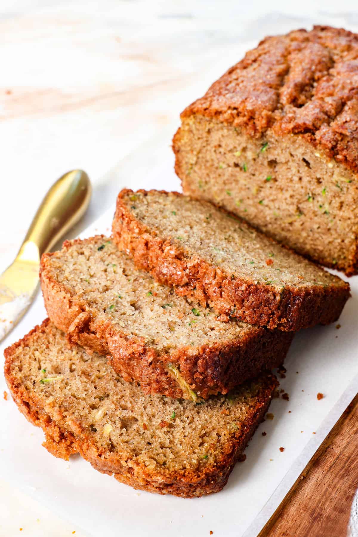 best zucchini bread recipe with a few slices on a cutting board showing how moist it is